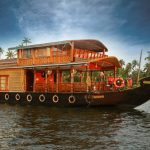 One-bedroom premium luxury houseboat cruising through the peaceful backwaters of Alleppey, ideal for couples or solo travelers.