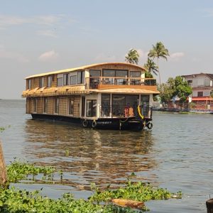 Eight-bedroom Alleppey houseboat cruising on Vembanad Lake at sunset