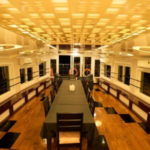 Upper deck lounge with panoramic seating on large houseboat